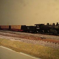 Pulpwood train. IHCX Mogul on point. Train show trainset cars in tow.